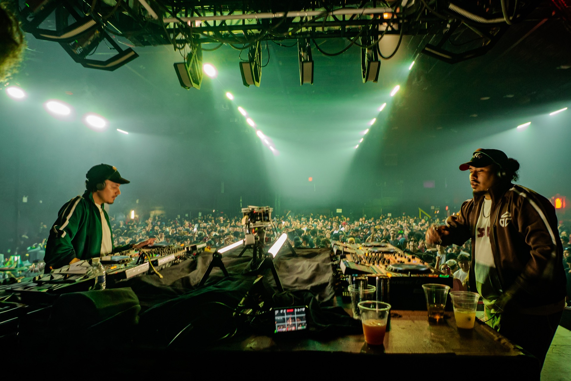 DJs behind the decks with massive crowd