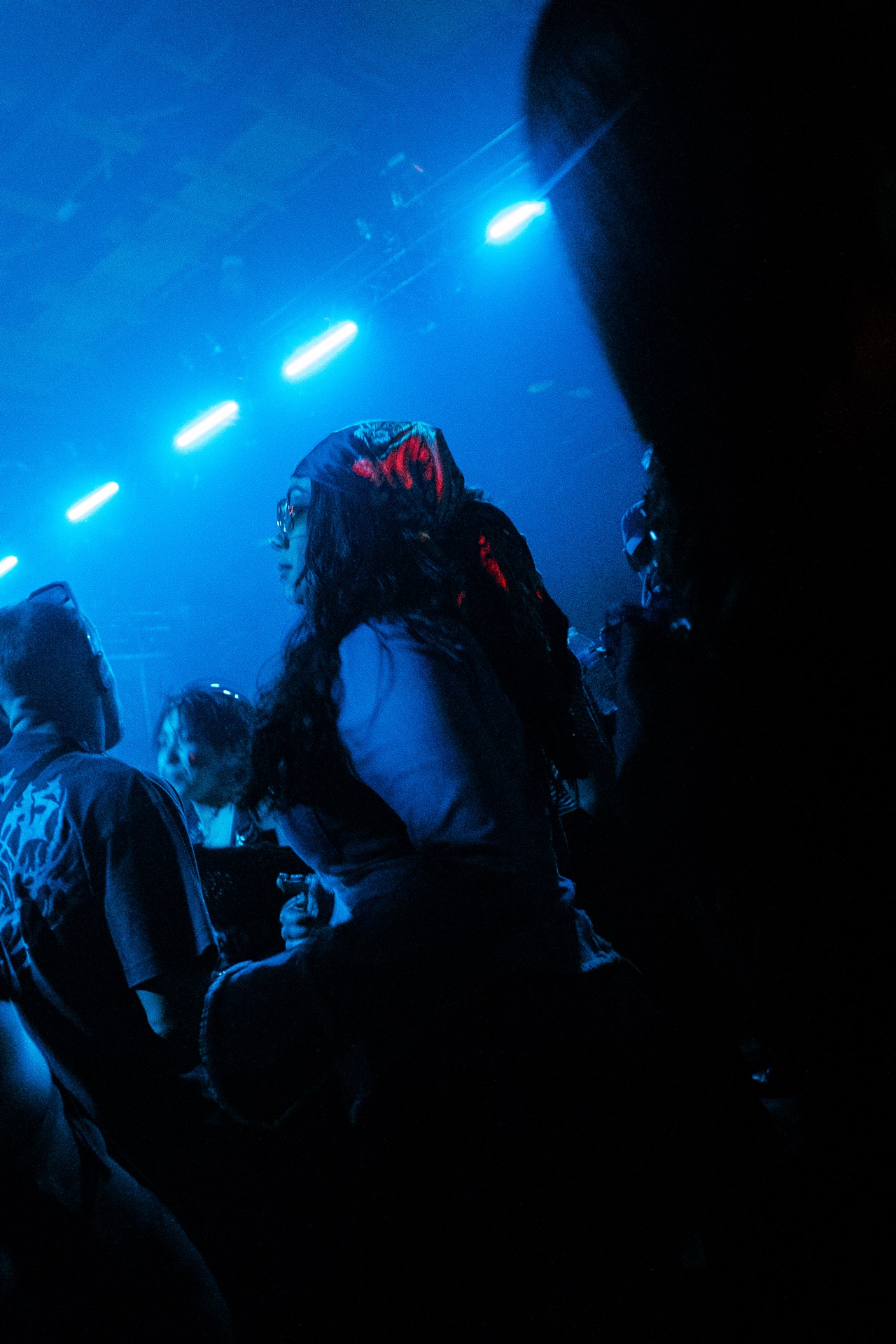 Blue-lit crowd silhouette